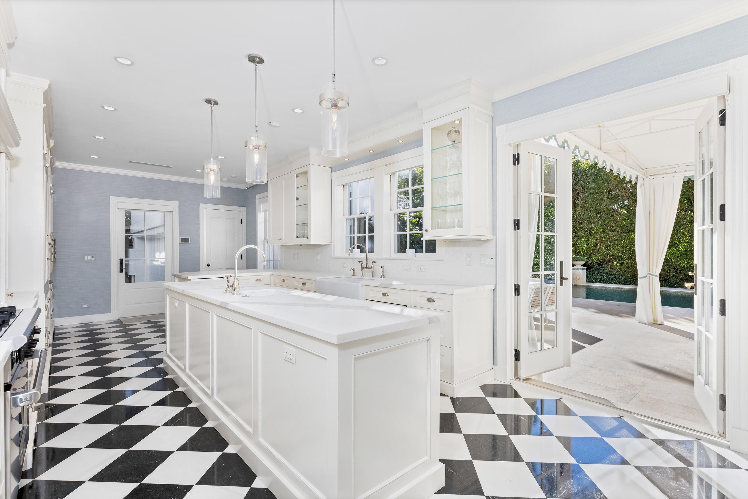 130 Cocoanut Row Palm Beach, FL 33480 - Photo 25 of 66 a large white kitchen with a sink and cabinets