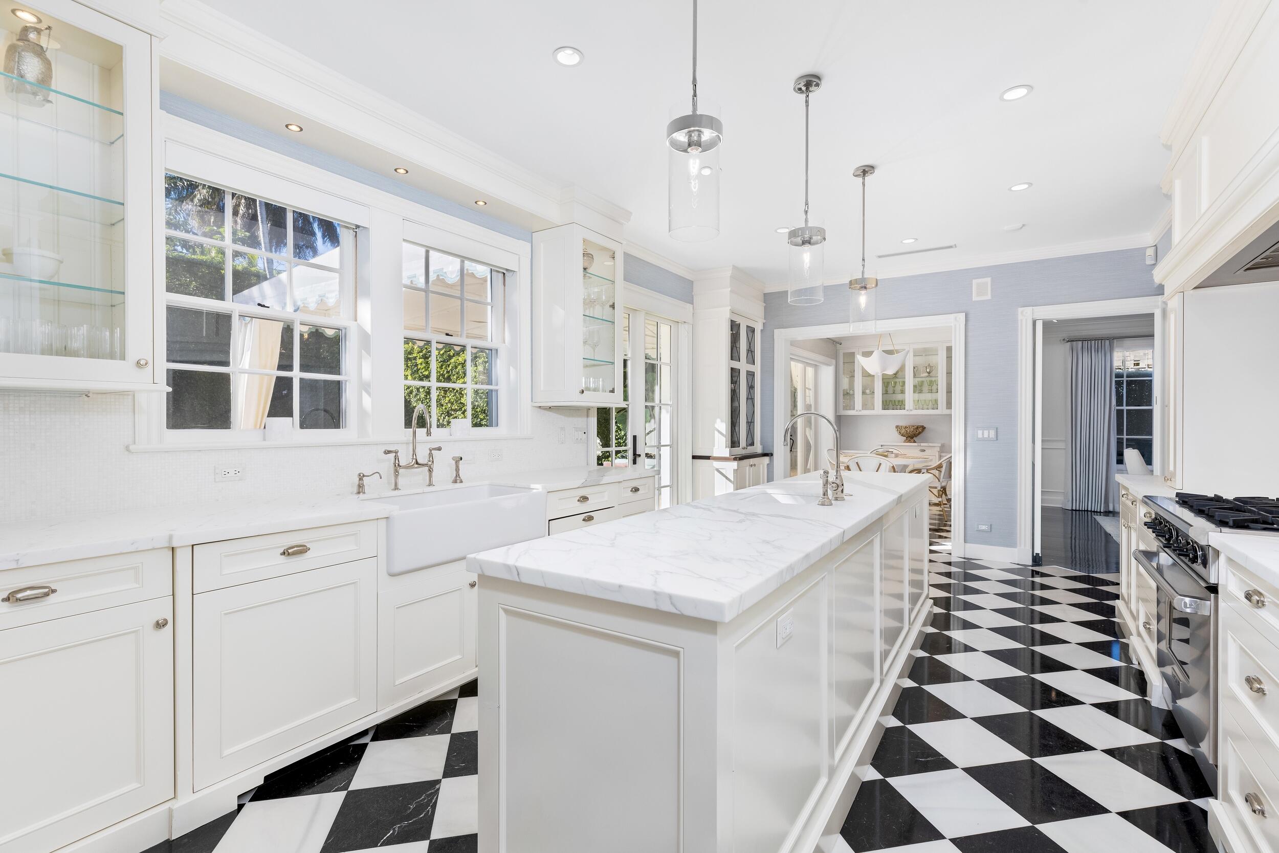 130 Cocoanut Row Palm Beach, FL 33480 - Photo 28 of 66 a large white kitchen with a sink and cabinets