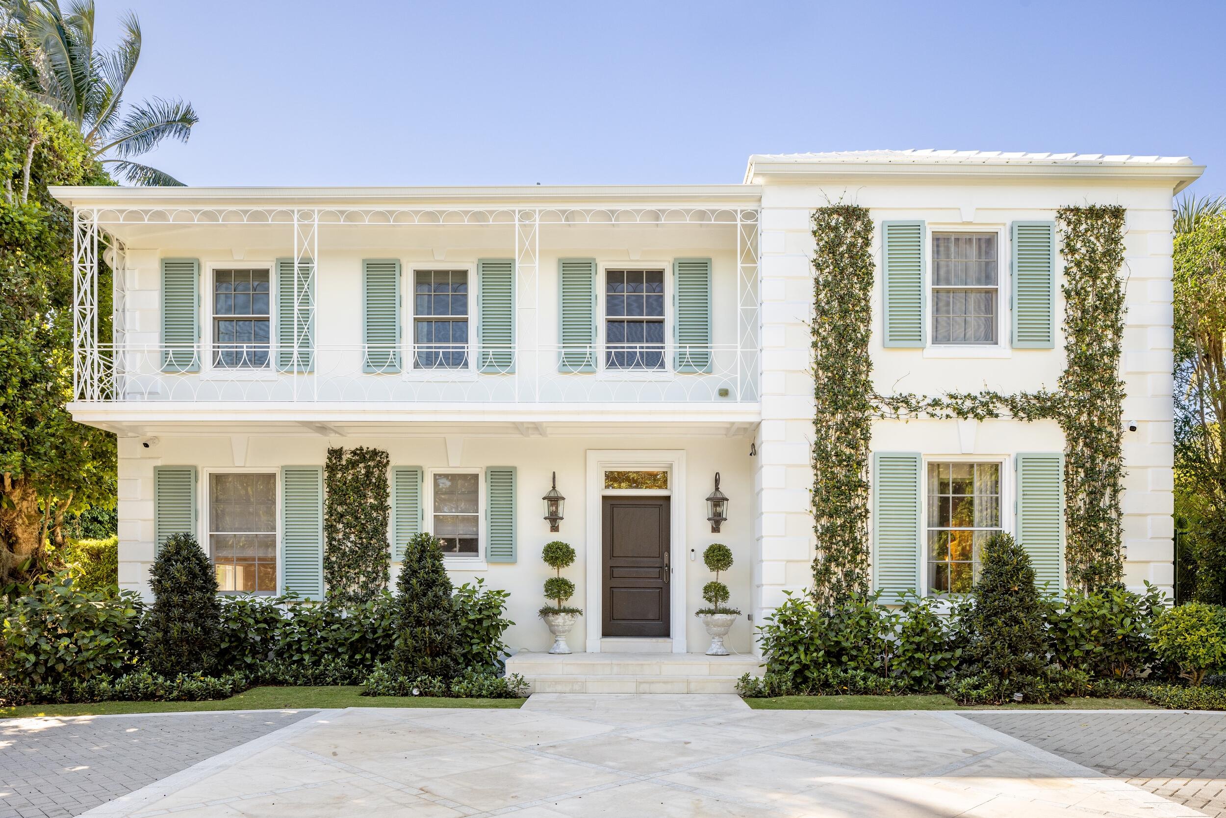 130 Cocoanut Row Palm Beach, FL 33480 - Photo 4 of 66 front view of a brick house with potted plants