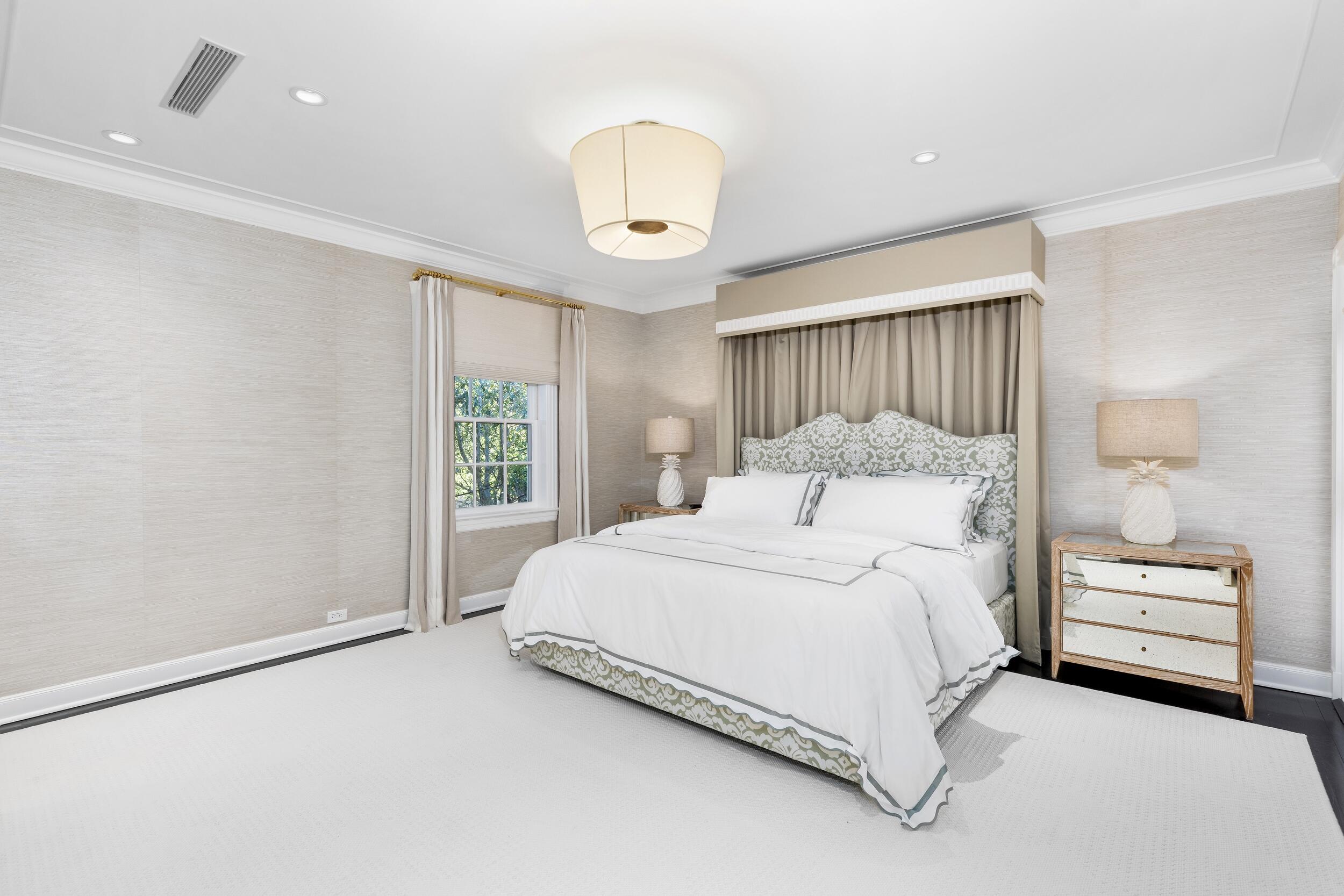 130 Cocoanut Row Palm Beach, FL 33480 - Photo 43 of 66 a bedroom with a bed and a chandelier