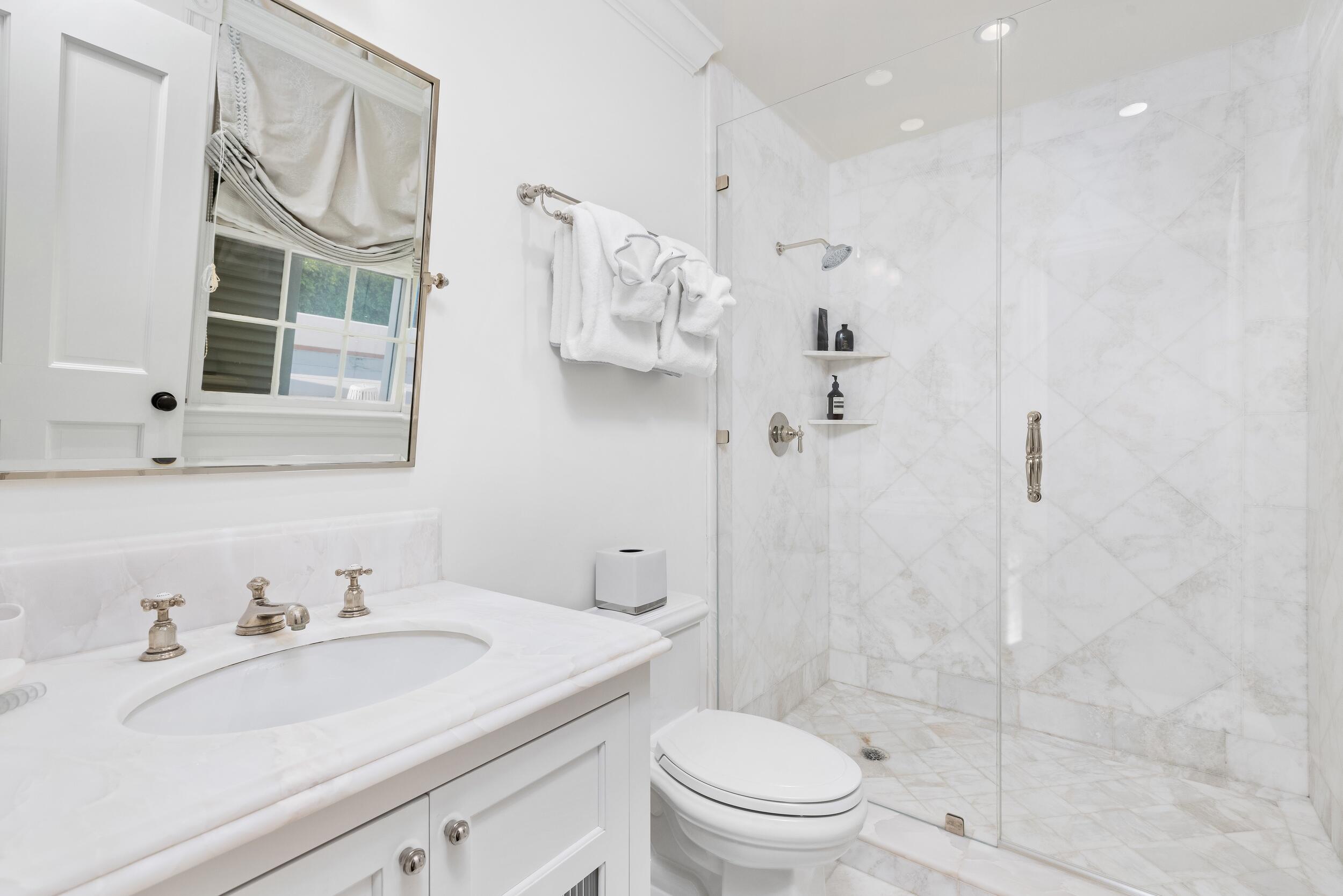 130 Cocoanut Row Palm Beach, FL 33480 - Photo 50 of 66 a bathroom with a sink toilet a mirror and shower