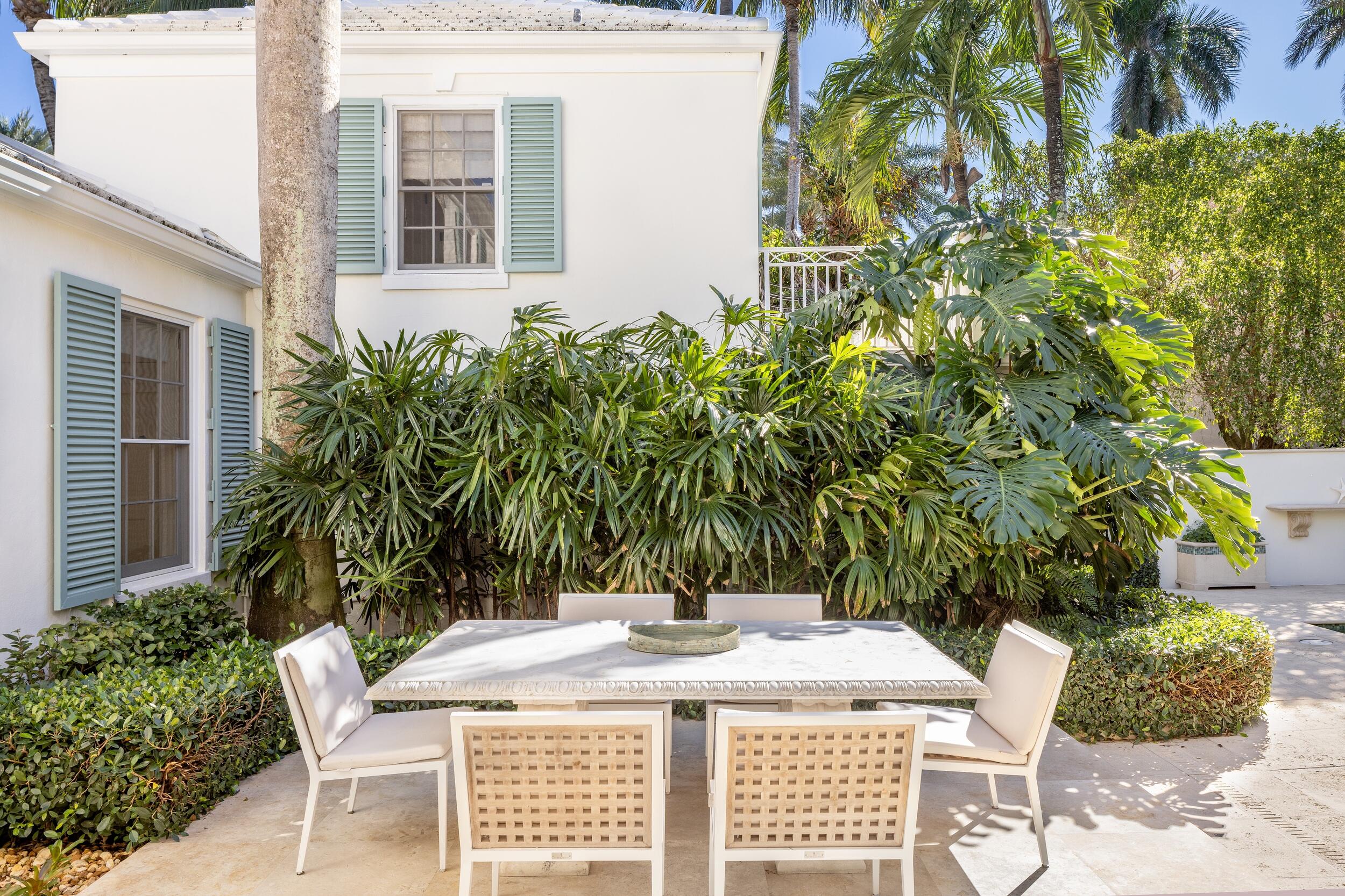 130 Cocoanut Row Palm Beach, FL 33480 - Photo 51 of 66 a view of a patio with table and chairs potted plants