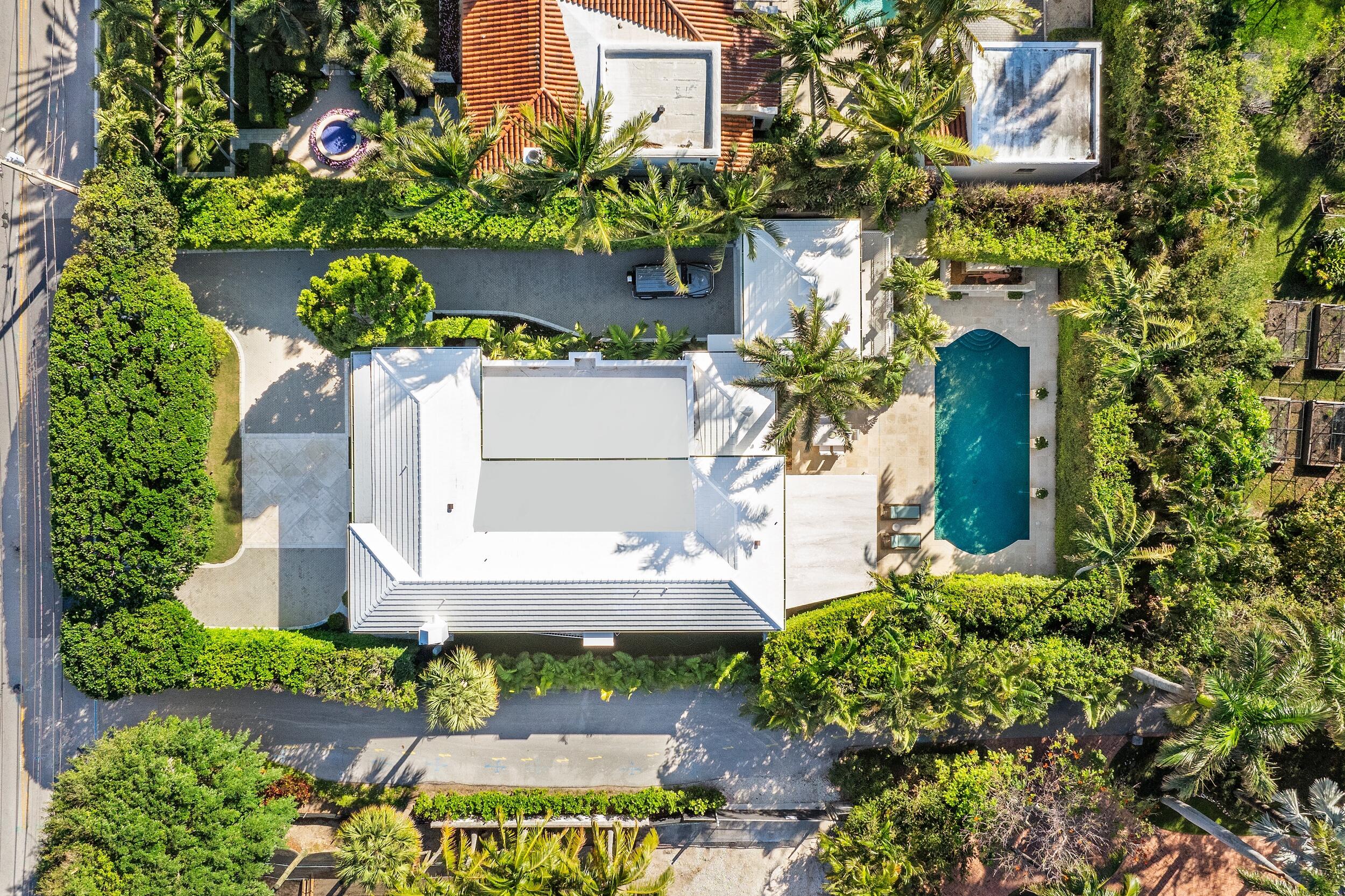 130 Cocoanut Row Palm Beach, FL 33480 - Photo 59 of 66 front view of a house with a yard and potted plants