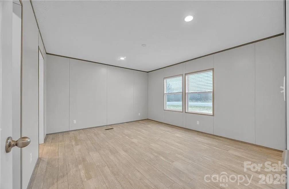 4935 Rhoney Road Connelly Springs, NC 28612 - Photo 16 of 36 an empty room with a empty space and windows