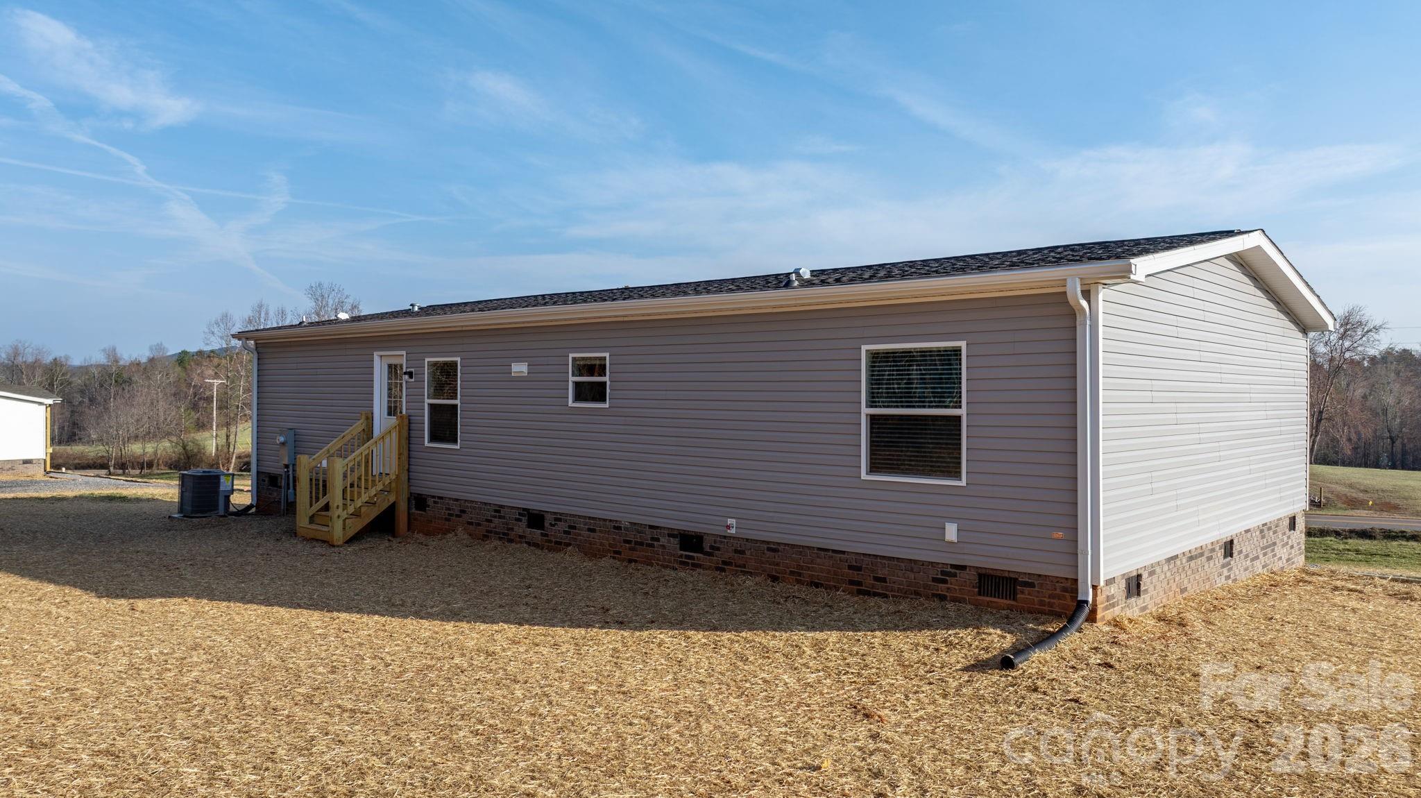 4935 Rhoney Road Connelly Springs, NC 28612 - Photo 32 of 36 a front view of a house with a yard