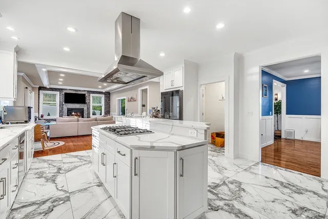 a kitchen with stainless steel appliances kitchen island granite countertop a sink and cabinets