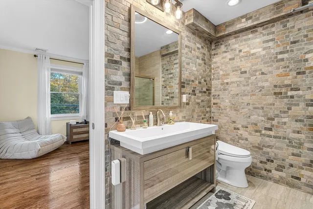 a bathroom with a sink toilet and mirror