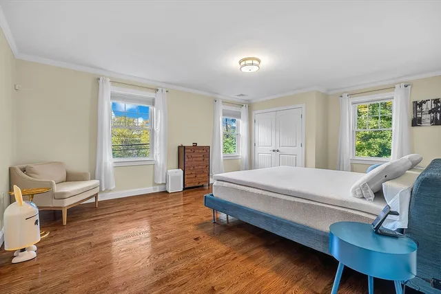 a bedroom with a bed and a chair