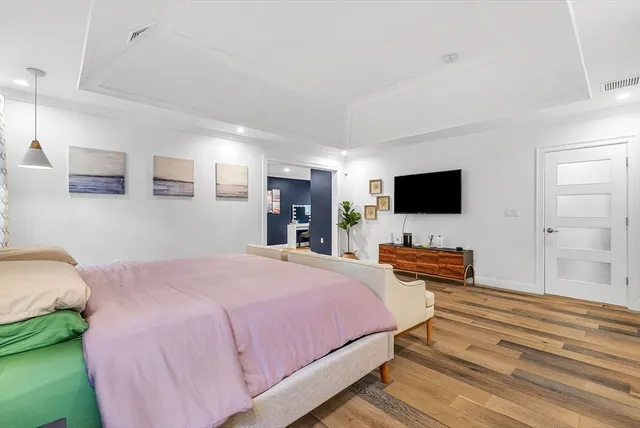 a bedroom with a bed and a flat screen tv