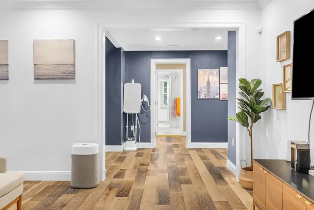 a bedroom with a bed and a potted plant