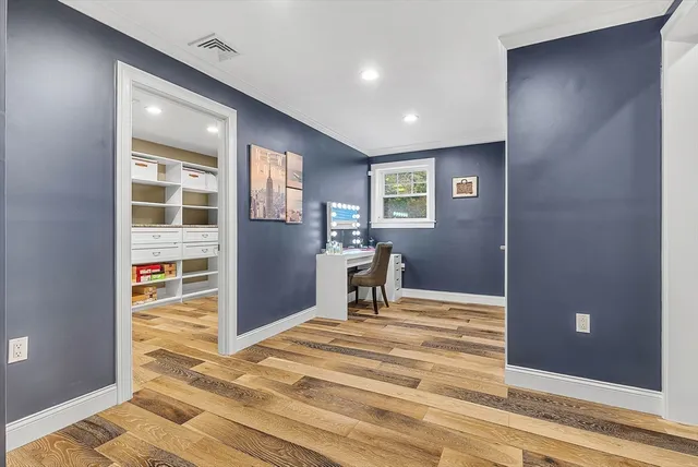 a view of a livingroom with wooden floor and chair