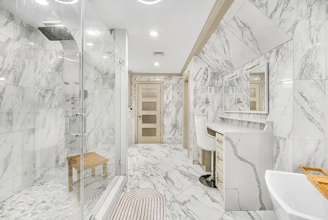 a bathroom with a bathtub and shower