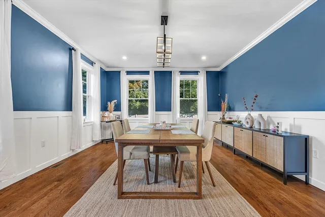 a view of a dining room with furniture window and wooden floor