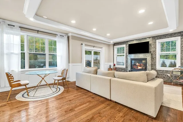 a living room with furniture a fireplace and a flat screen tv
