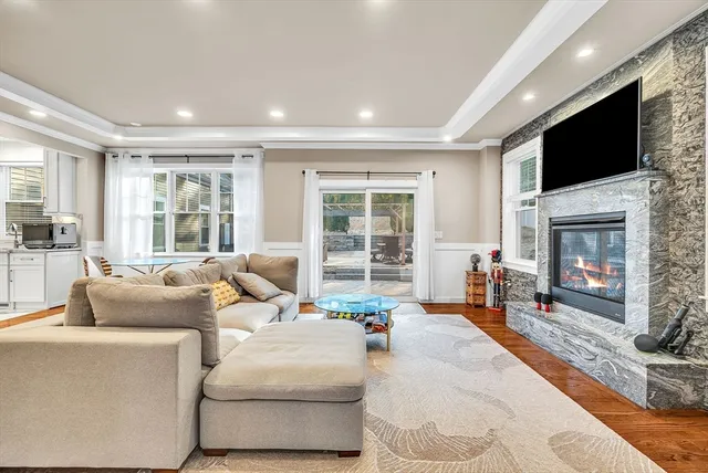 a living room with fireplace furniture and a flat screen tv