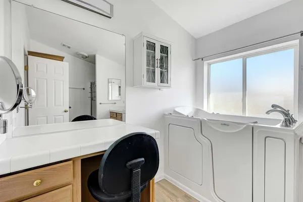 a view of walk in closet with wooden floor