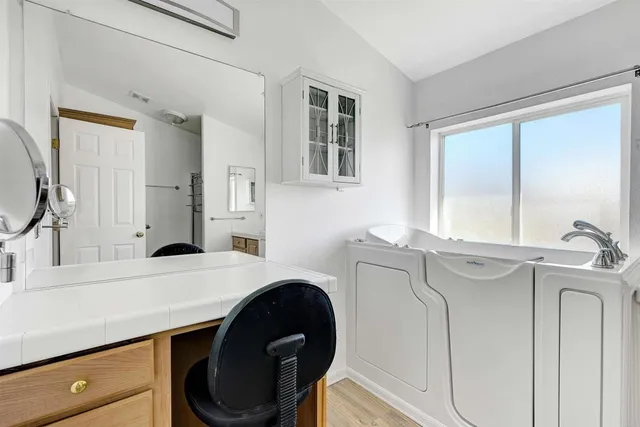 a view of walk in closet with wooden floor