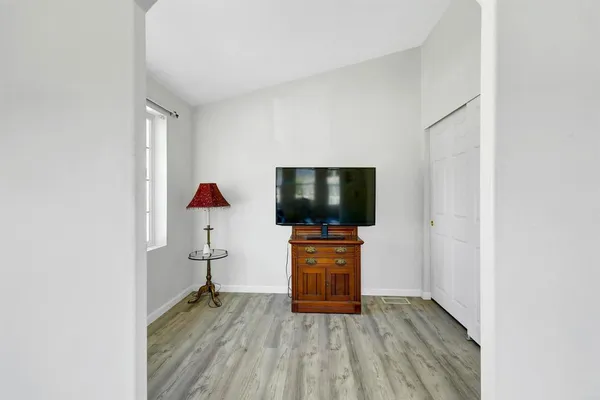a view of a workspace with furniture and a window