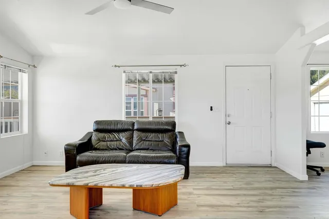 a spacious bedroom with a bed a couch and a chandelier