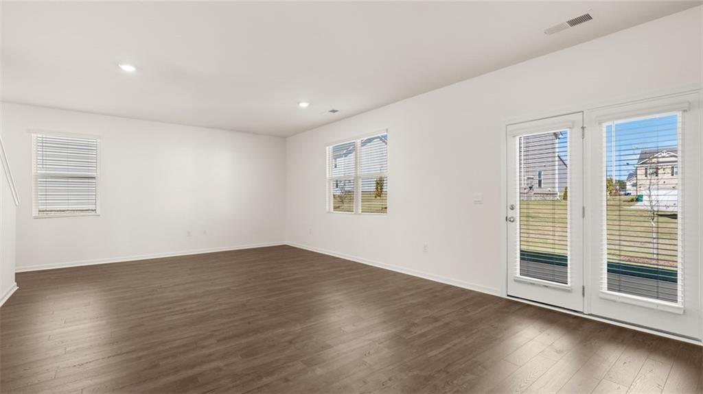 81 White Spruce Way Newnan, GA 30265 - Photo 13 of 39 a view of an empty room with wooden floor and a window