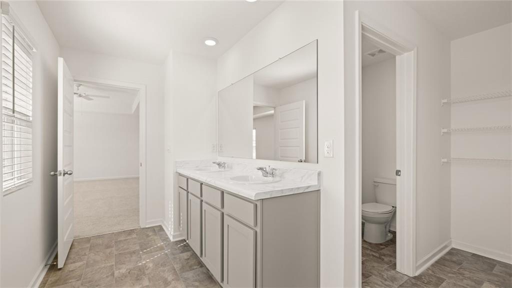 81 White Spruce Way Newnan, GA 30265 - Photo 22 of 39 a bathroom with a sink toilet and shower a mirror