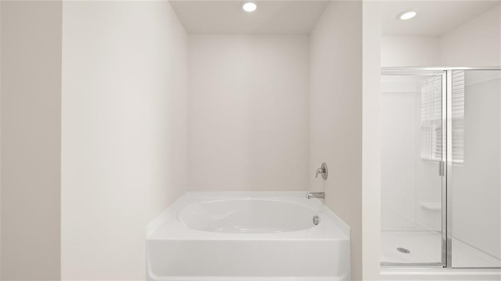 81 White Spruce Way Newnan, GA 30265 - Photo 24 of 39 a white bath tub sitting next to a shower
