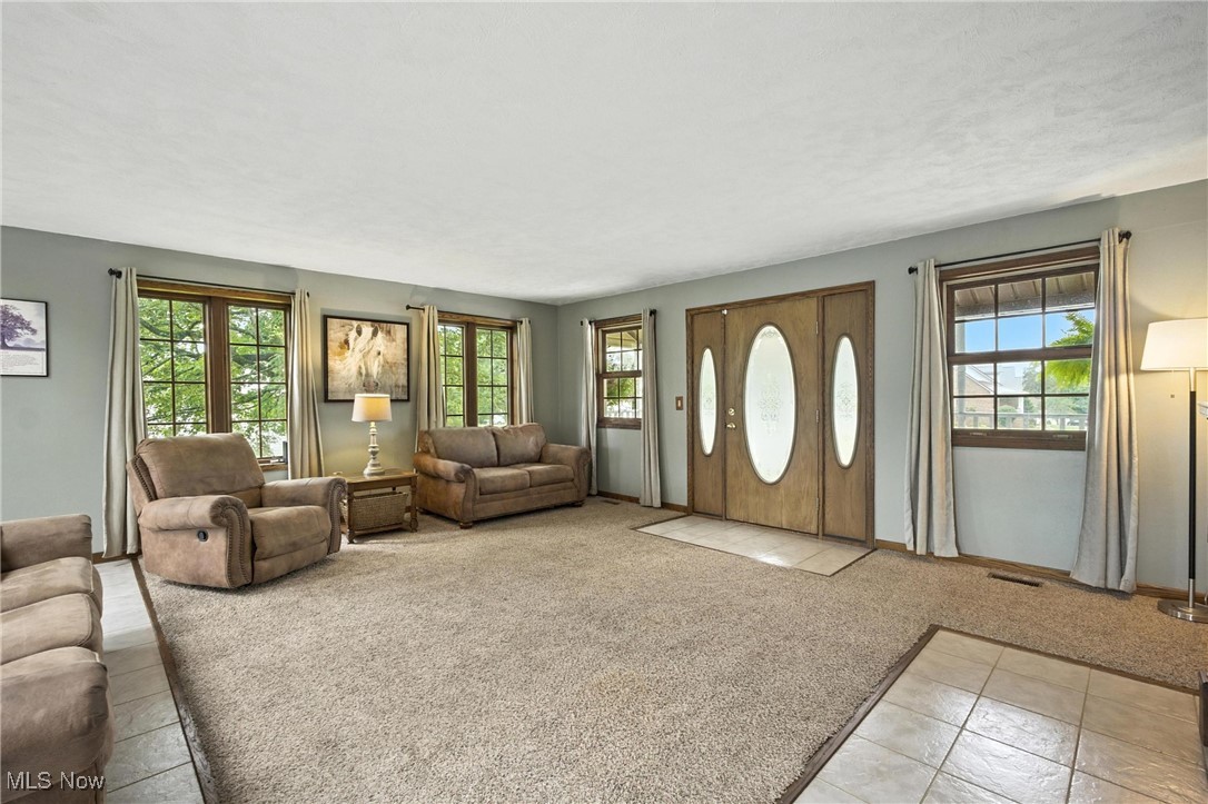 1371 Spider Ridge Road Parkersburg, WV 26104 - Photo 5 of 48 Living room featuring light carpet and light tile patterned floors