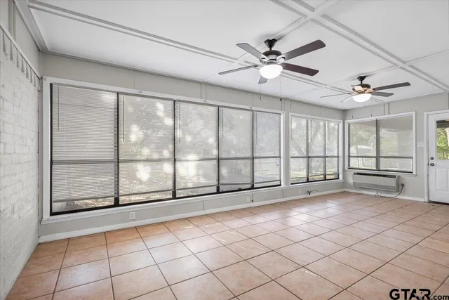 a view of a big room with wooden floor closet and windows