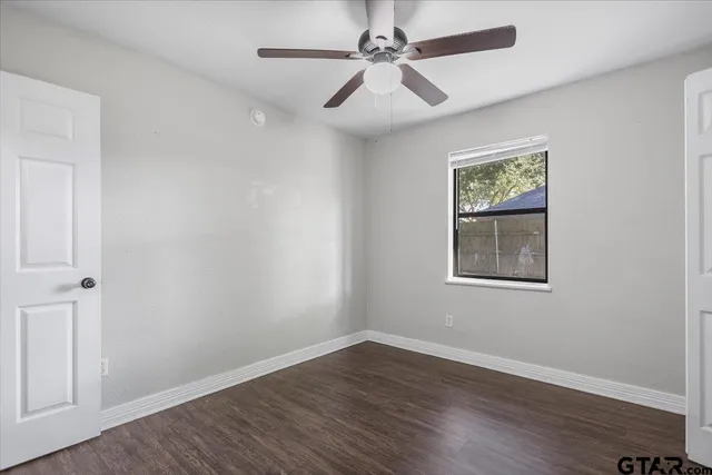 a bathroom with a granite countertop toilet a mirror and a sink