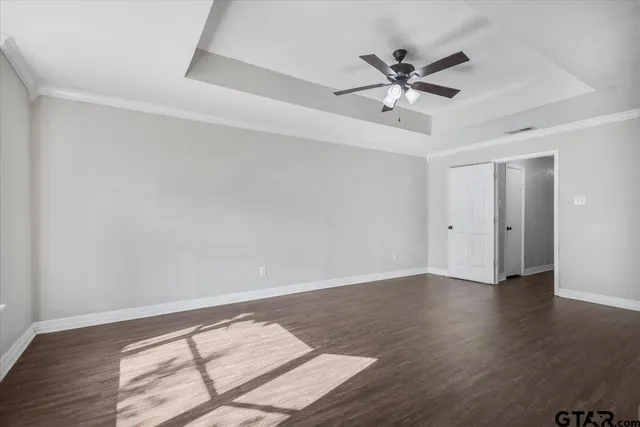 an aerial view of residential houses with city and green space