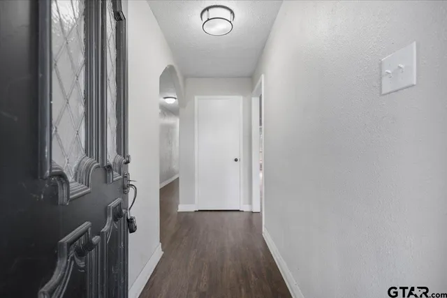 a view of an empty room with a fireplace and a window