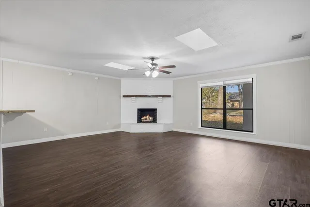 a view of a kitchen with a sink a fireplace and wooden floor