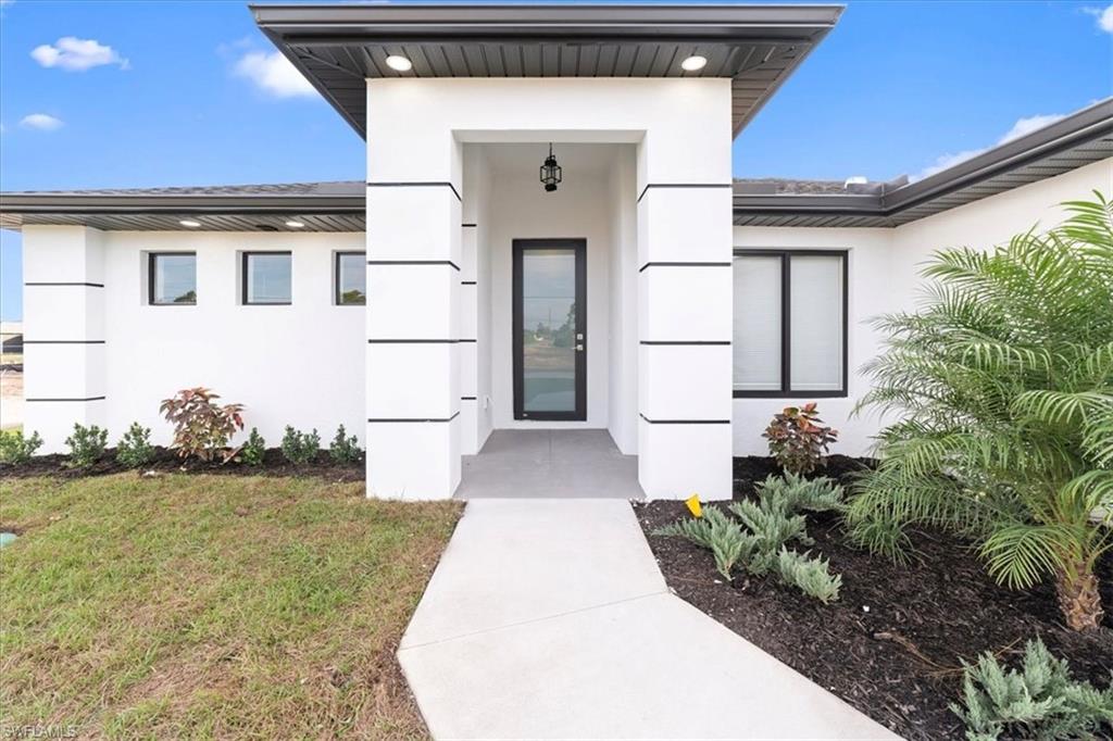 2619 23rd Street Southwest Lehigh Acres, FL 33976 - Photo 1 of 21 a view of a white house with a yard