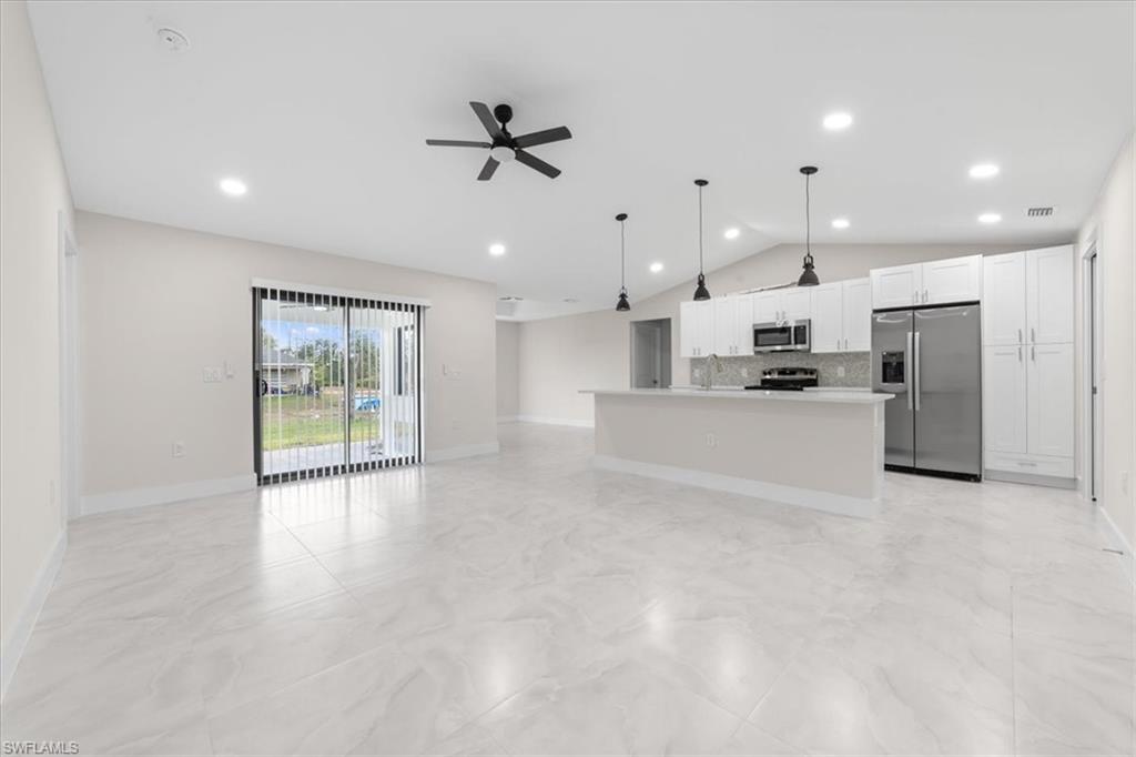 2619 23rd Street Southwest Lehigh Acres, FL 33976 - Photo 21 of 21 a view of a kitchen with furniture and a ceiling fan
