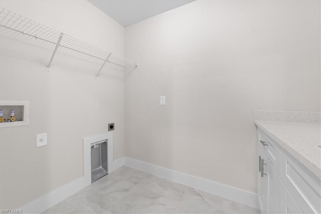 2619 23rd Street Southwest Lehigh Acres, FL 33976 - Photo 5 of 21 a view of a room with racks on the wall