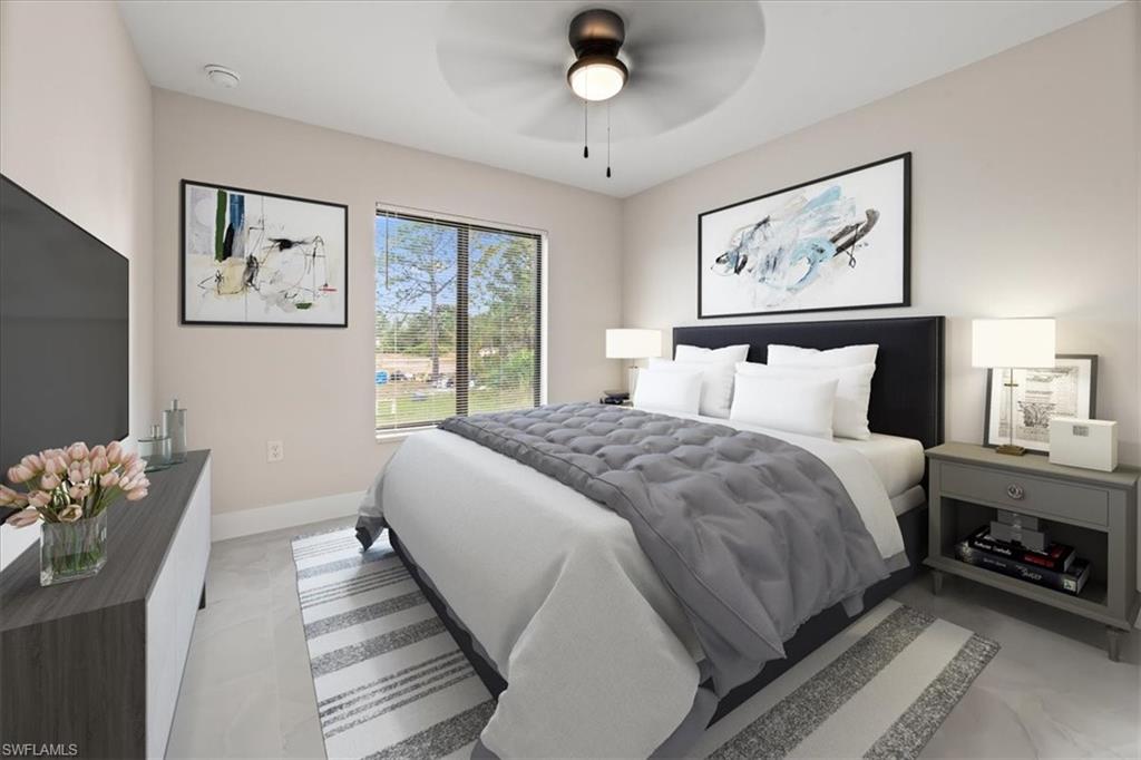 2619 23rd Street Southwest Lehigh Acres, FL 33976 - Photo 9 of 21 a bedroom with a large bed and a chandelier