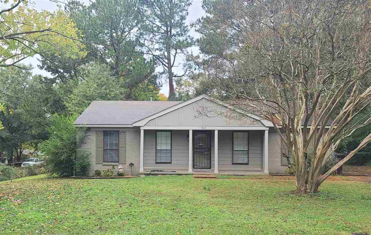 915 Greenview Road Collierville, TN 38017 - Photo 1 of 13 a front view of a house with a garden and trees