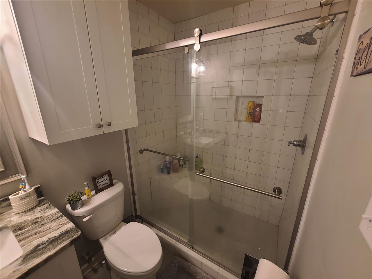 915 Greenview Road Collierville, TN 38017 - Photo 6 of 13 a white toilet sitting next to a bathroom sink and a shower