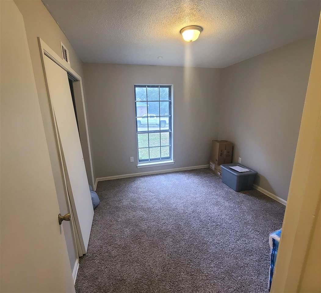 915 Greenview Road Collierville, TN 38017 - Photo 7 of 13 an empty room with windows