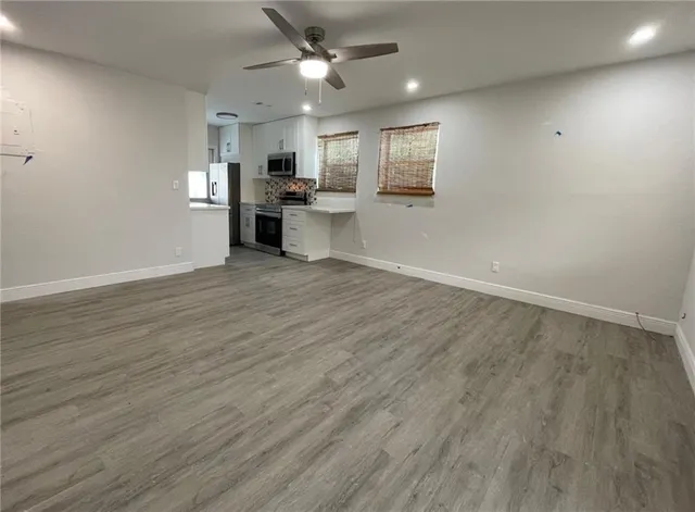 a view of a kitchen with a sink and a refrigerator