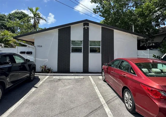 a front view of a house with parking area