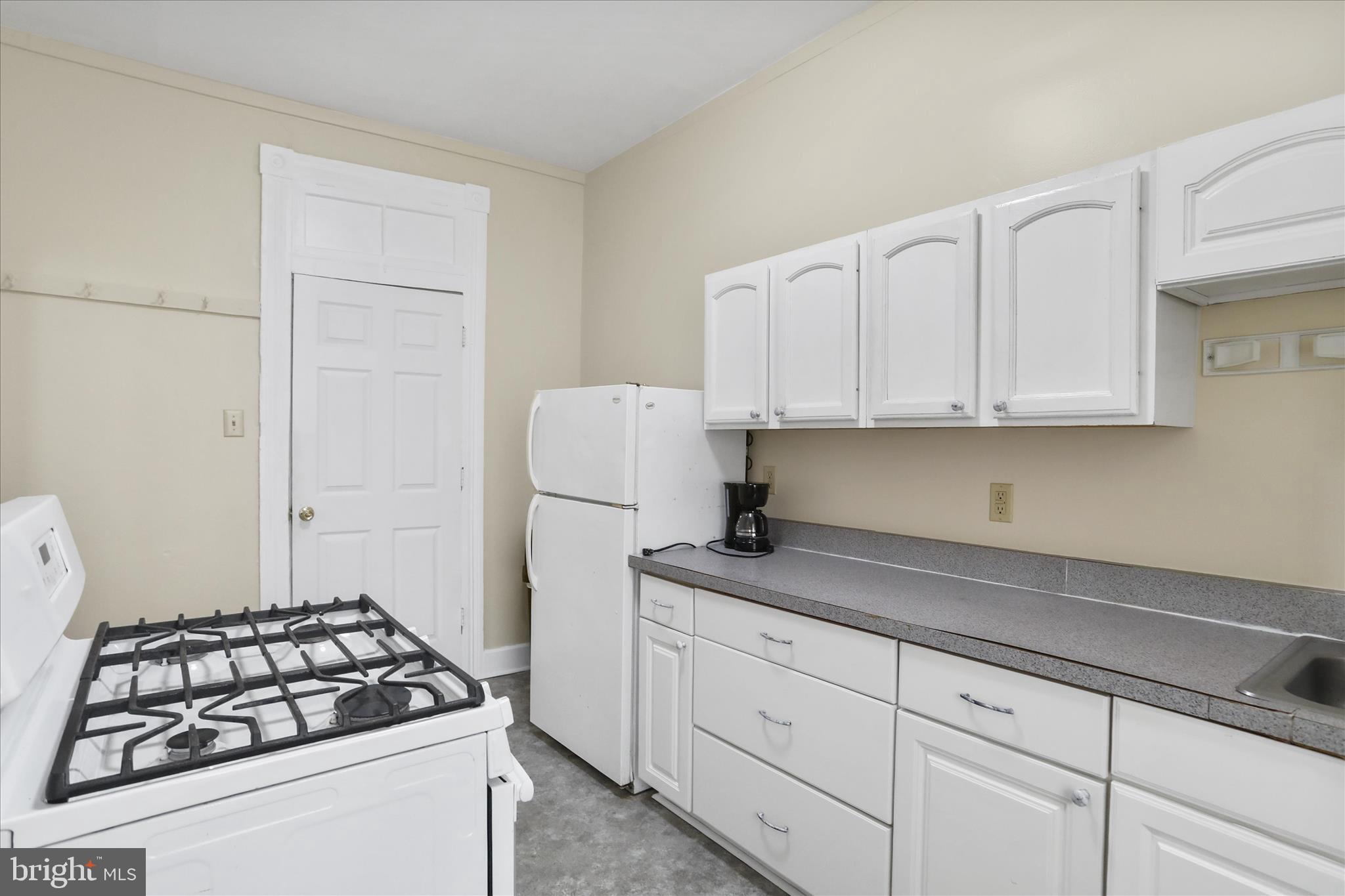 315 Frederick Street Cumberland, MD 21502 - Photo 11 of 46 a kitchen with white cabinets and appliances