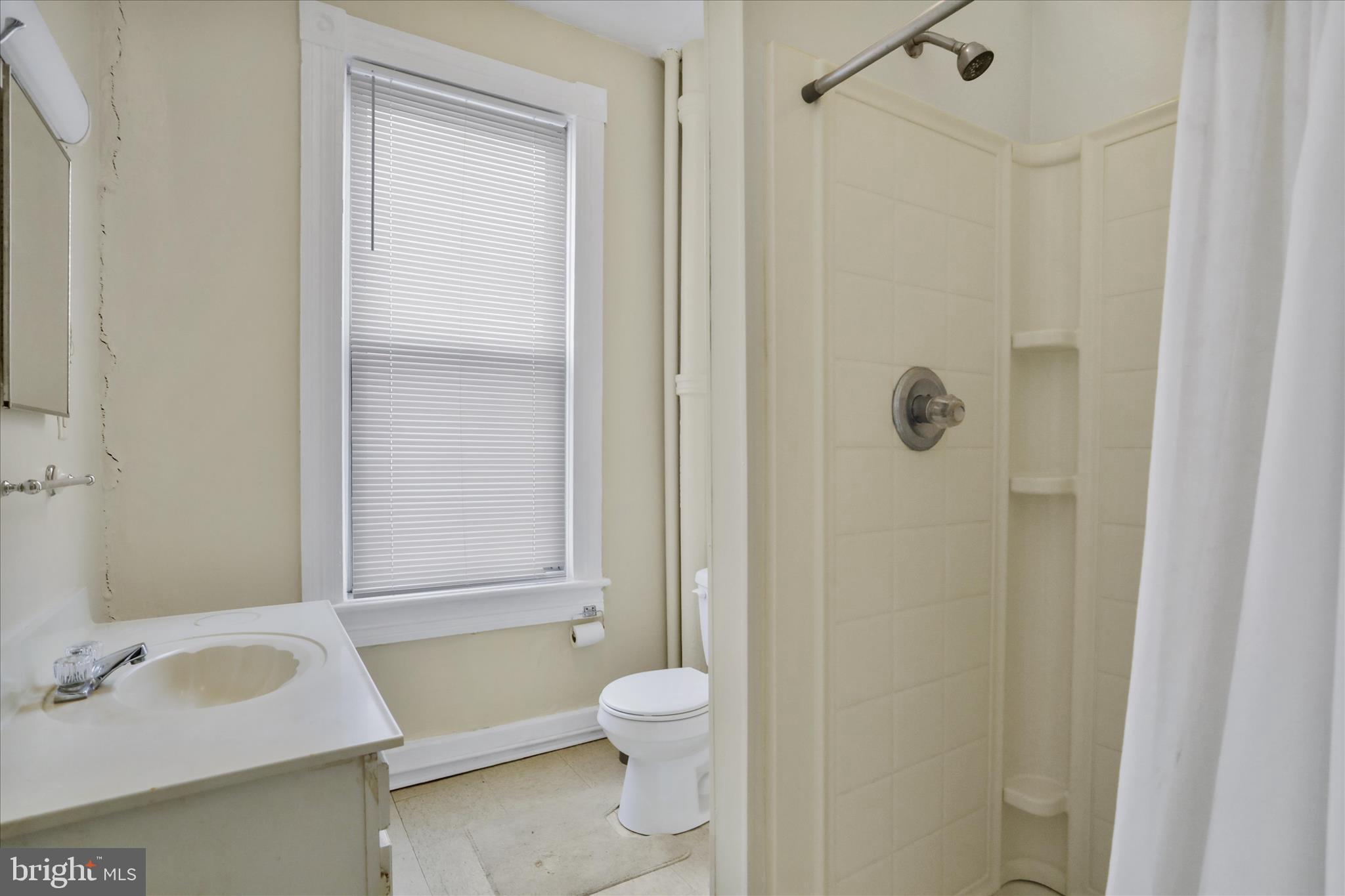 315 Frederick Street Cumberland, MD 21502 - Photo 14 of 46 a bathroom with a sink toilet and shower