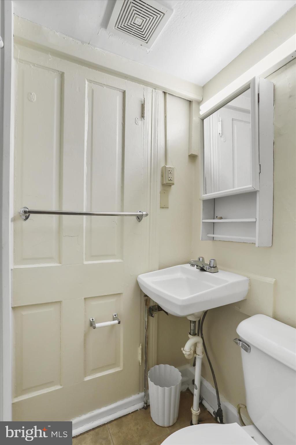 315 Frederick Street Cumberland, MD 21502 - Photo 18 of 46 a bathroom with a sink and a mirror