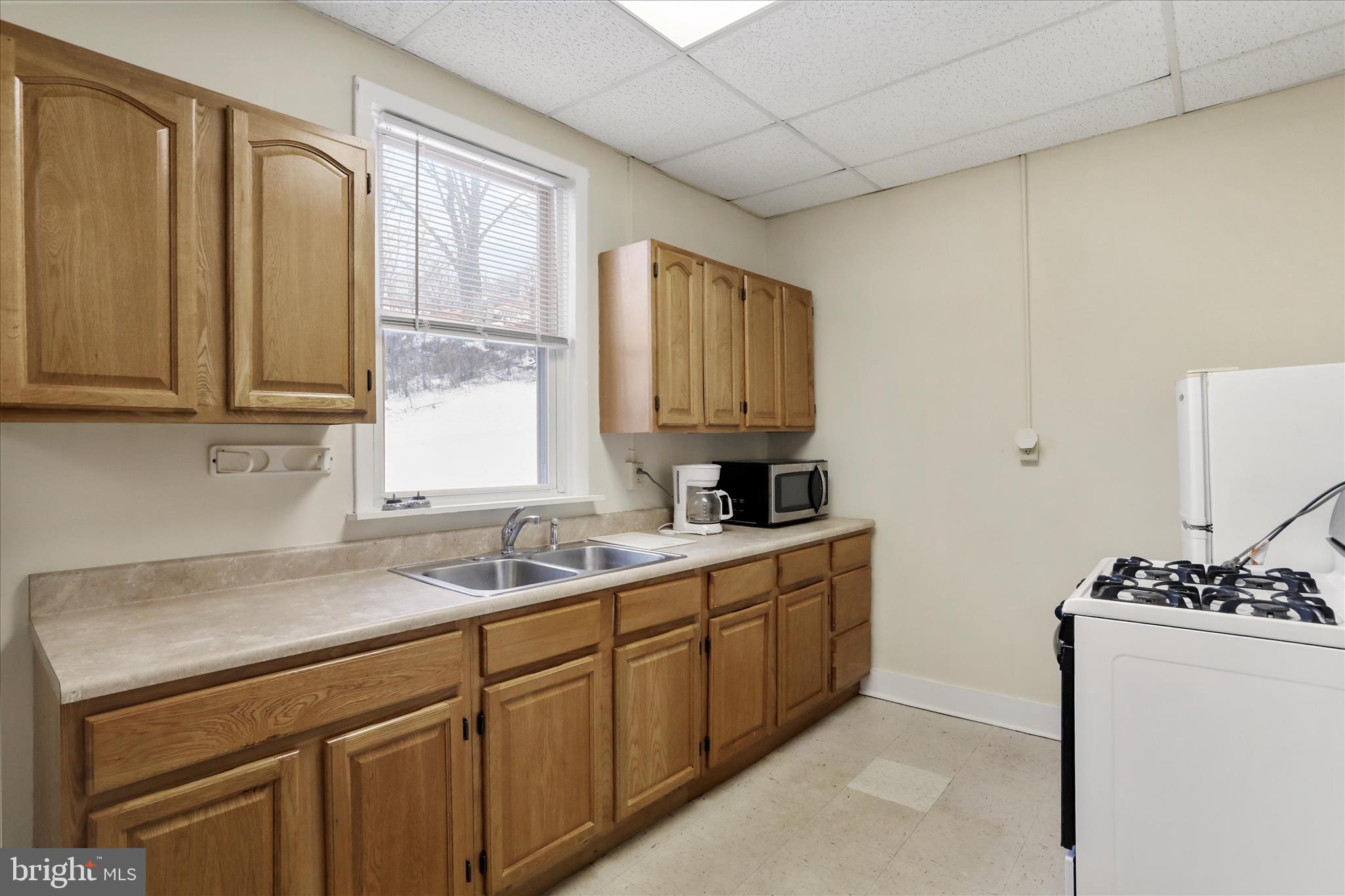 315 Frederick Street Cumberland, MD 21502 - Photo 23 of 46 a kitchen with stainless steel appliances granite countertop a sink stove and cabinets