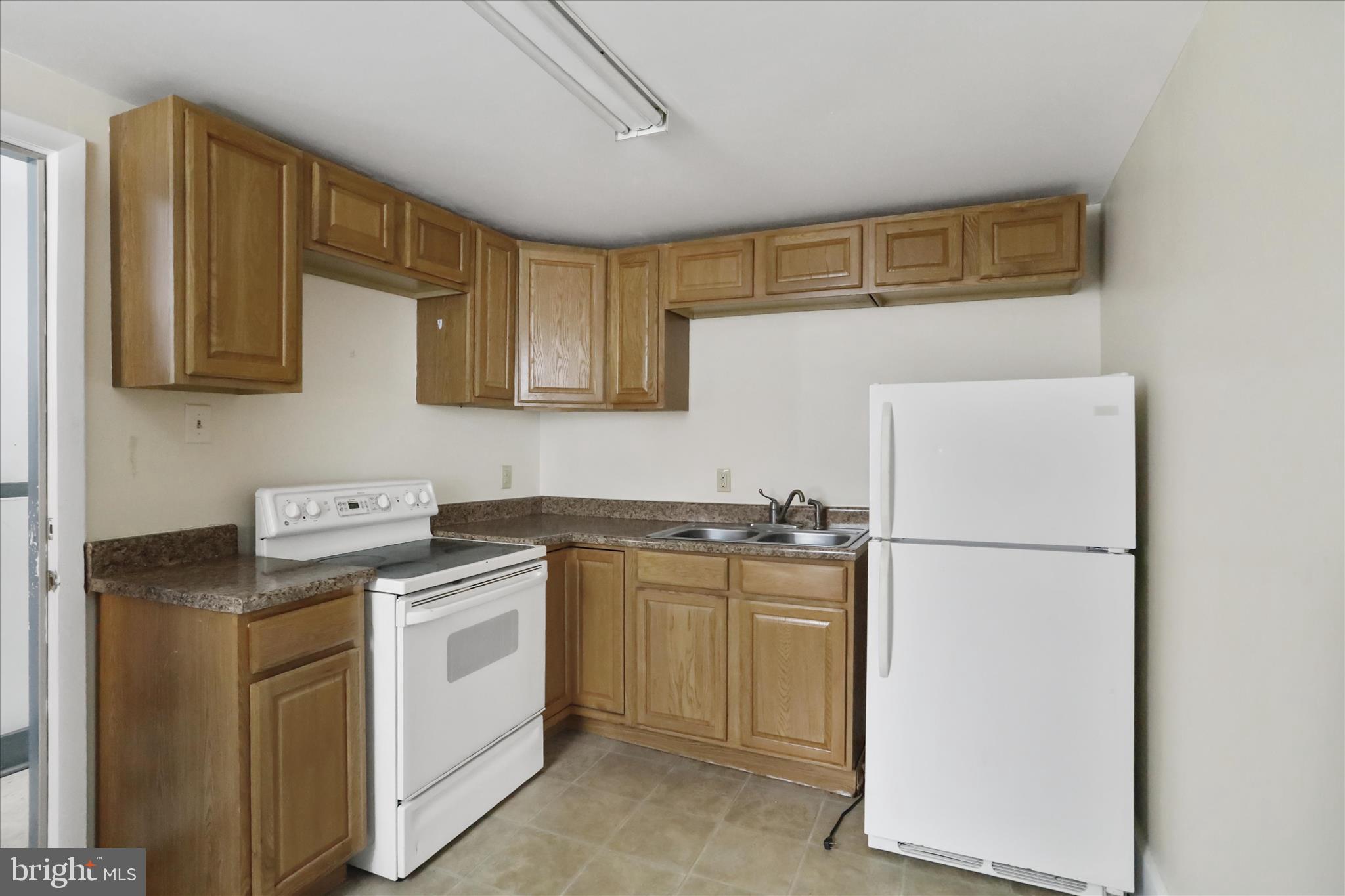 315 Frederick Street Cumberland, MD 21502 - Photo 31 of 46 a kitchen with appliances a sink and cabinets