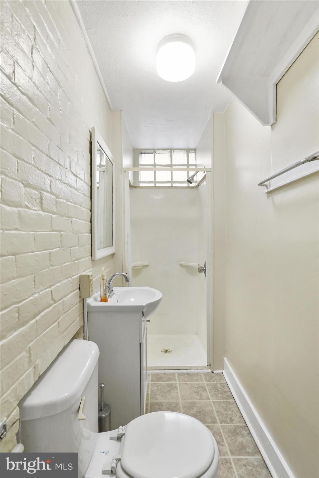 315 Frederick Street Cumberland, MD 21502 - Photo 33 of 46 a bathroom with a toilet a sink and mirror