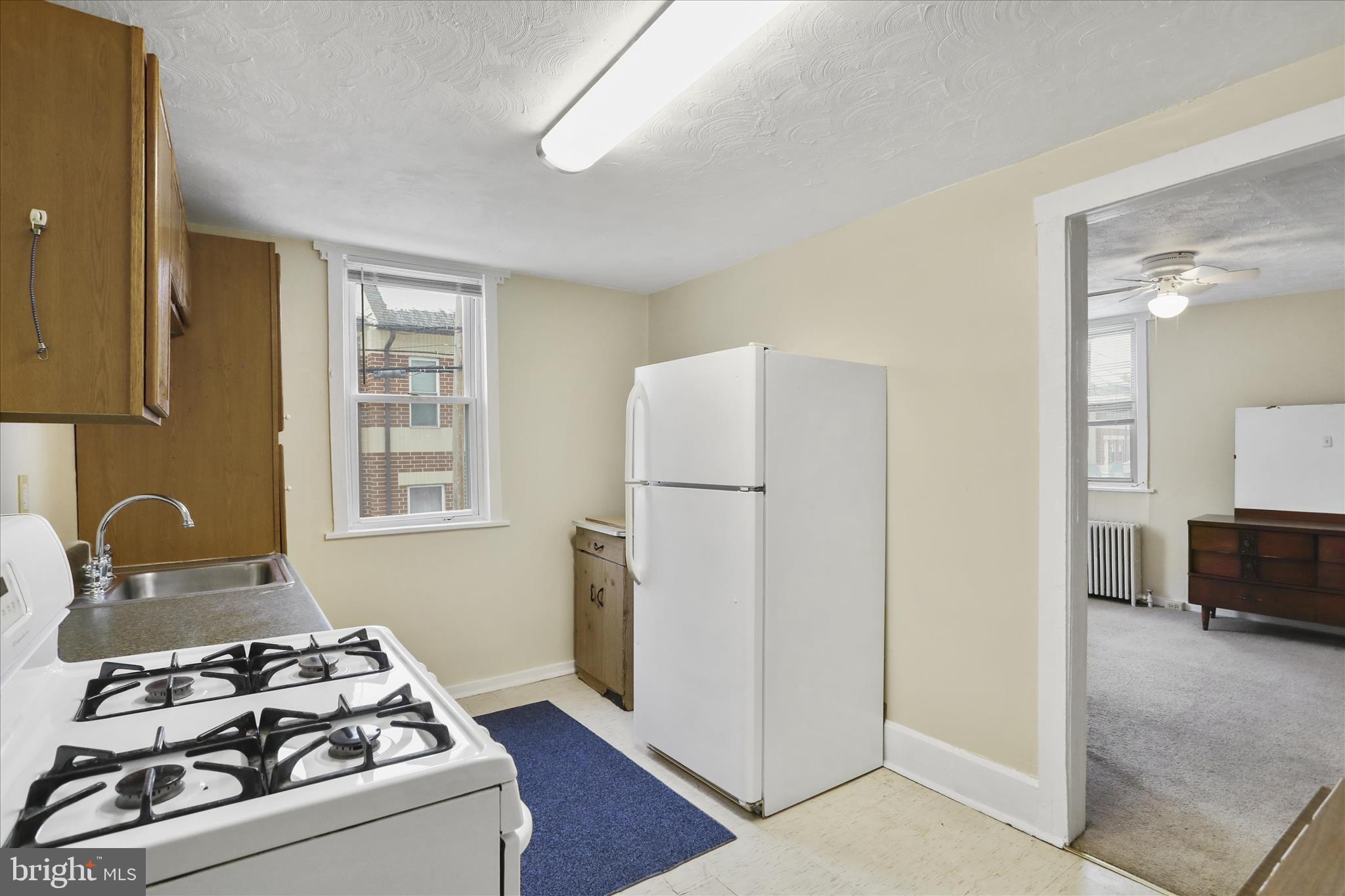 315 Frederick Street Cumberland, MD 21502 - Photo 34 of 46 a kitchen with a refrigerator stove and sink