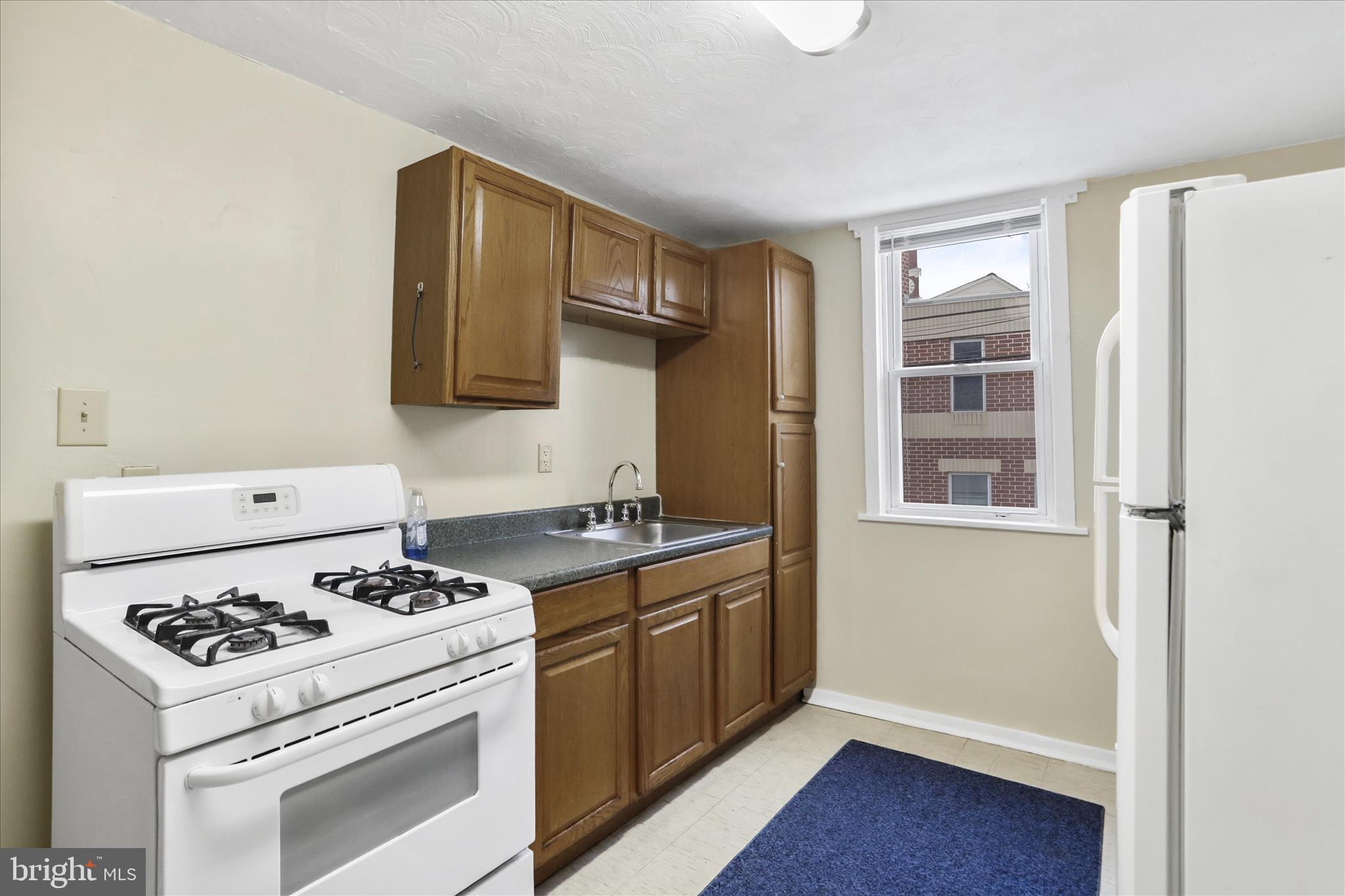 315 Frederick Street Cumberland, MD 21502 - Photo 35 of 46 a kitchen with a stove and a refrigerator