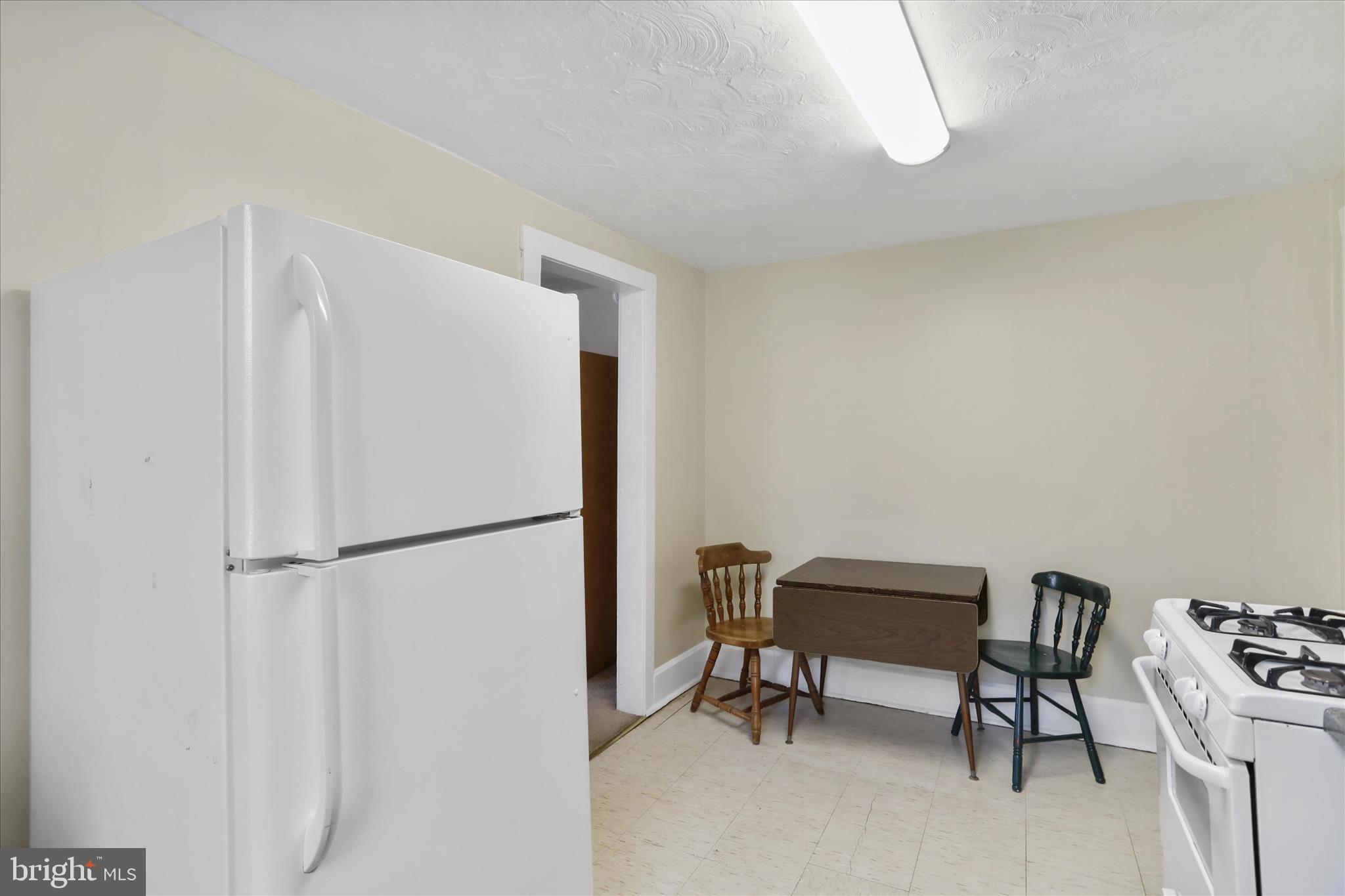 315 Frederick Street Cumberland, MD 21502 - Photo 36 of 46 a white refrigerator freezer sitting in a kitchen